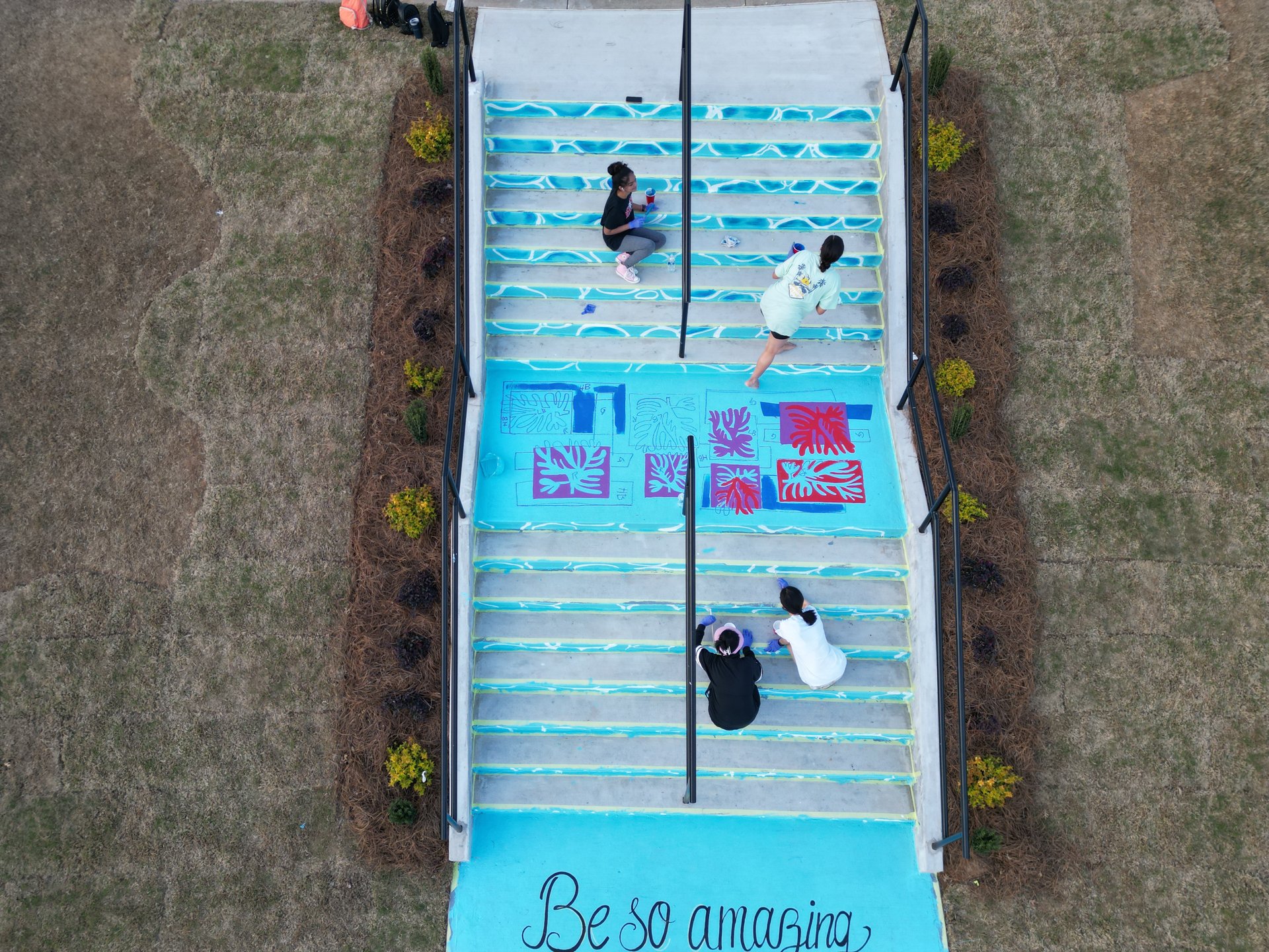 Participants painting the Cheers Spot stairs together